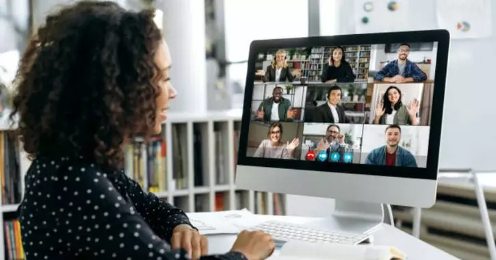 A woman sitting in front of a video call on her screen